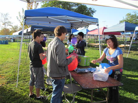 students blowing up balloons